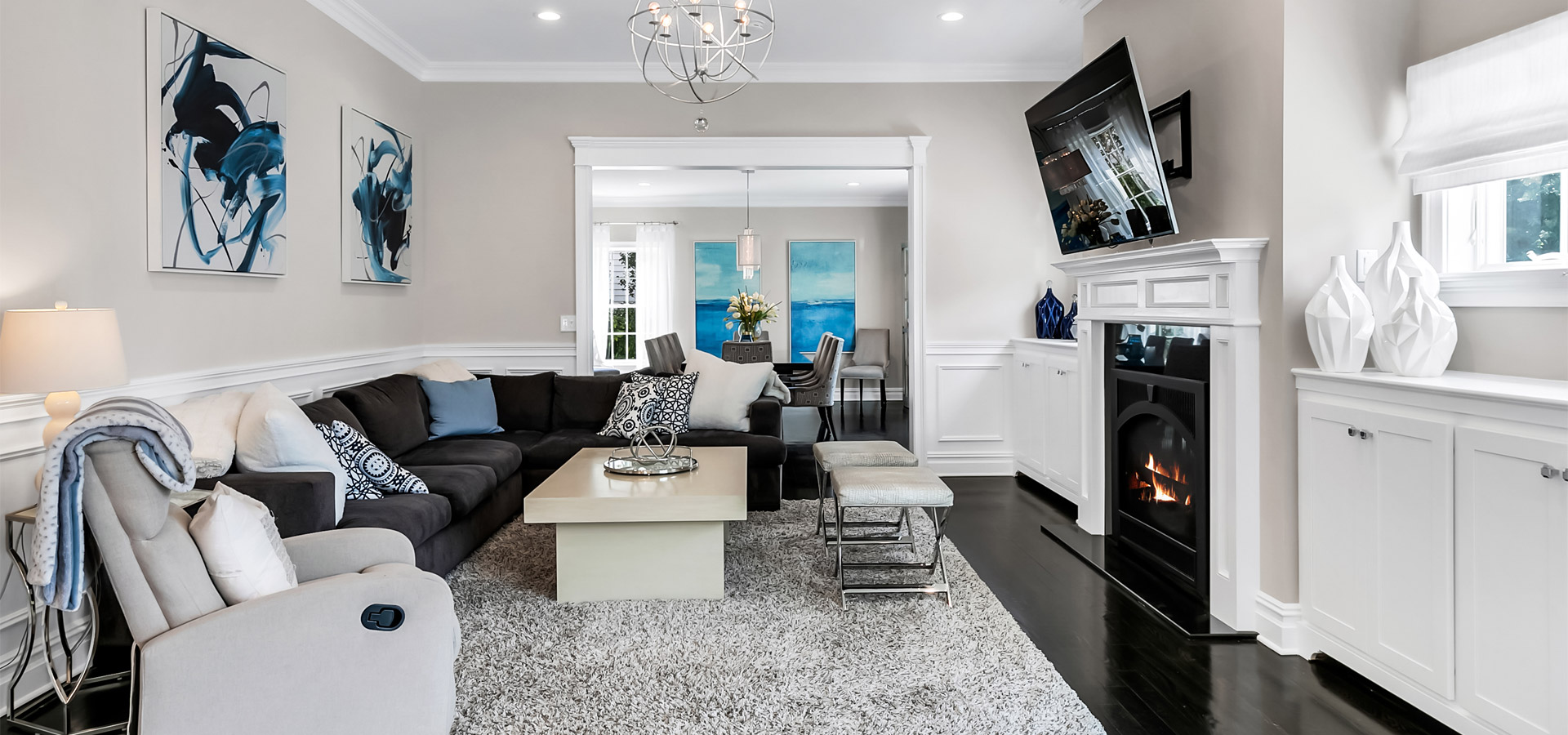 living room with black vinyl flooring and grey carpet