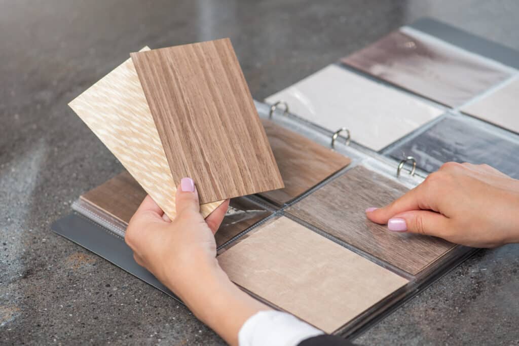 Customer looking over flooring samples from binder