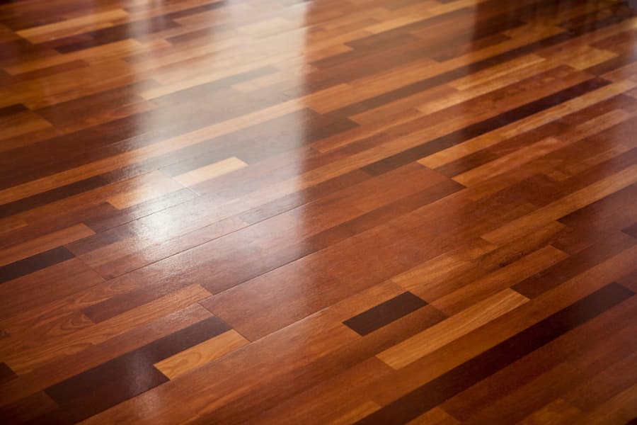 Polished hardwood flooring with light reflections