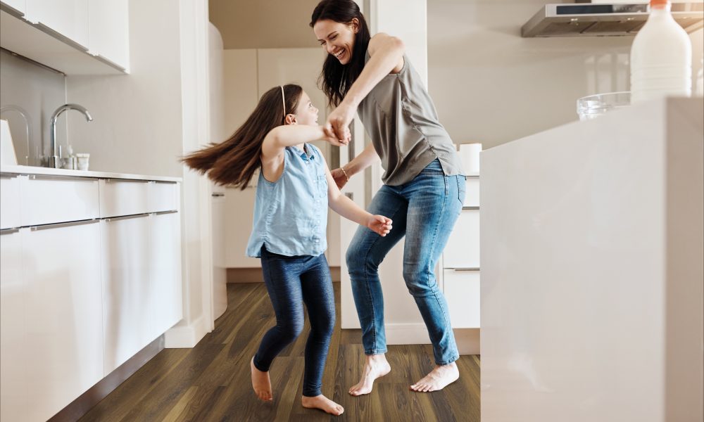 Shot of an adorable little girl dancing with her mother at home